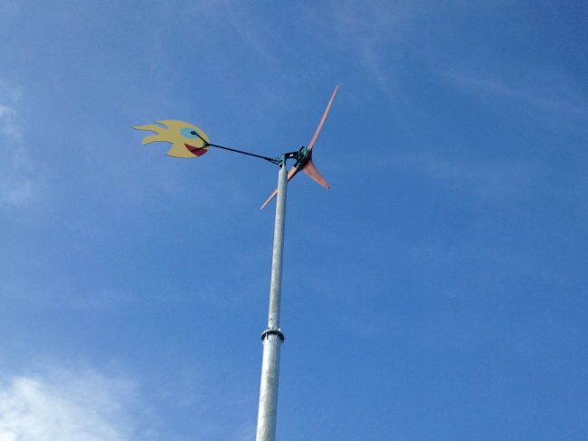 Wind turbine up and working. The tail fin was painted by local school children. 